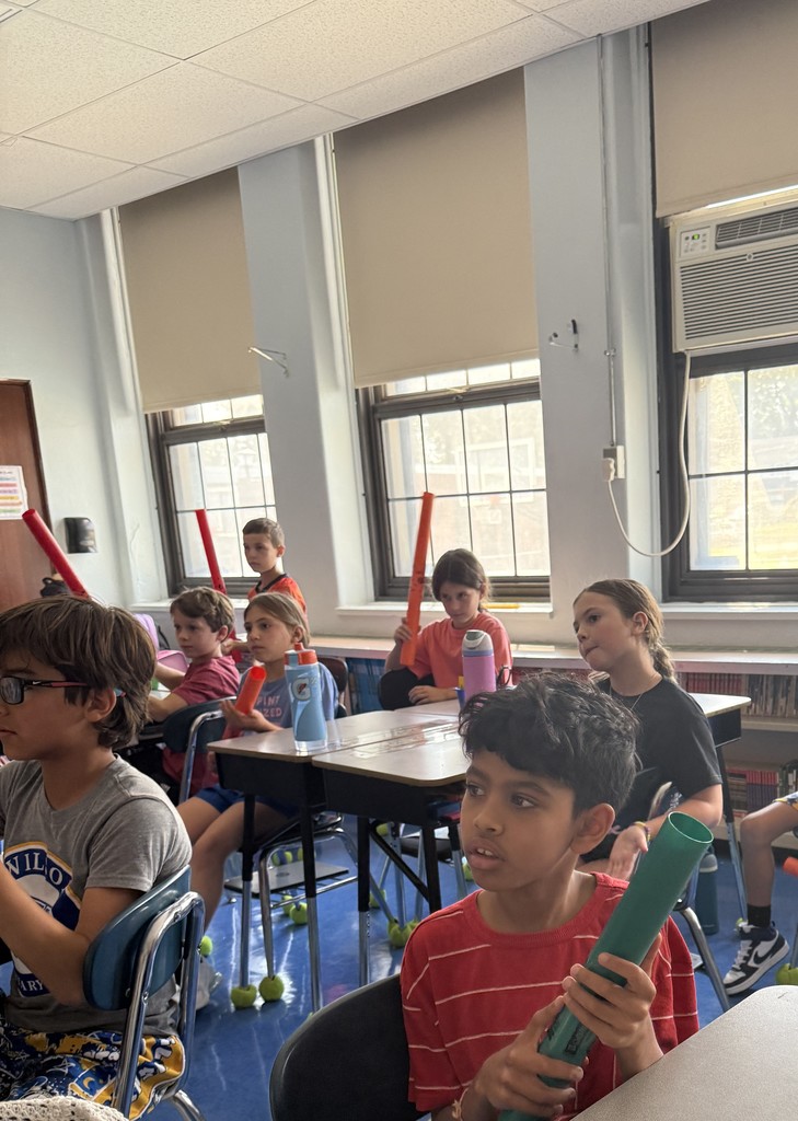 fourth grade students playing boomwhackers during music class