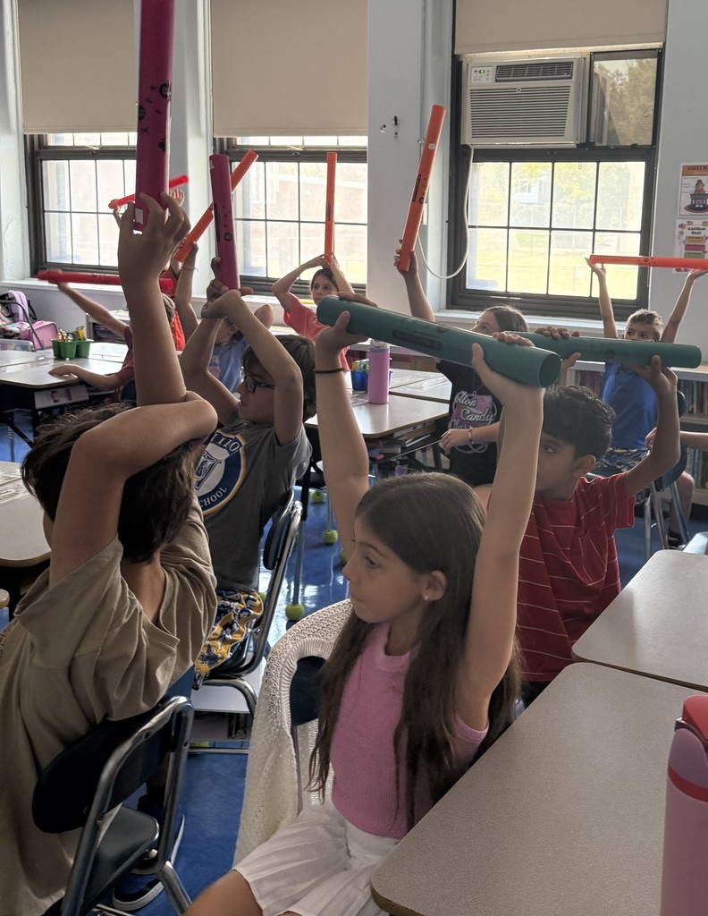 fourth grade students playing boomwhackers during music class