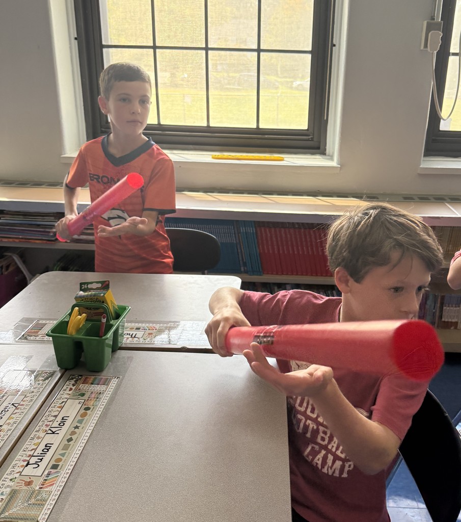 fourth grade students playing boomwhackers during music class