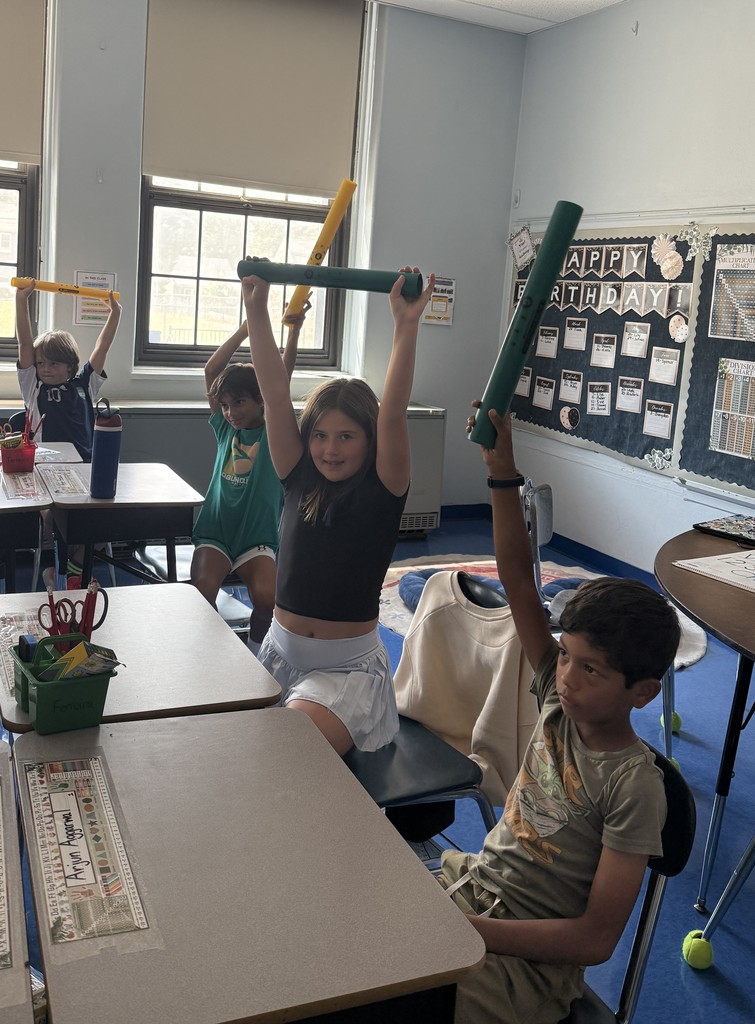 fourth grade students playing boomwhackers during music class