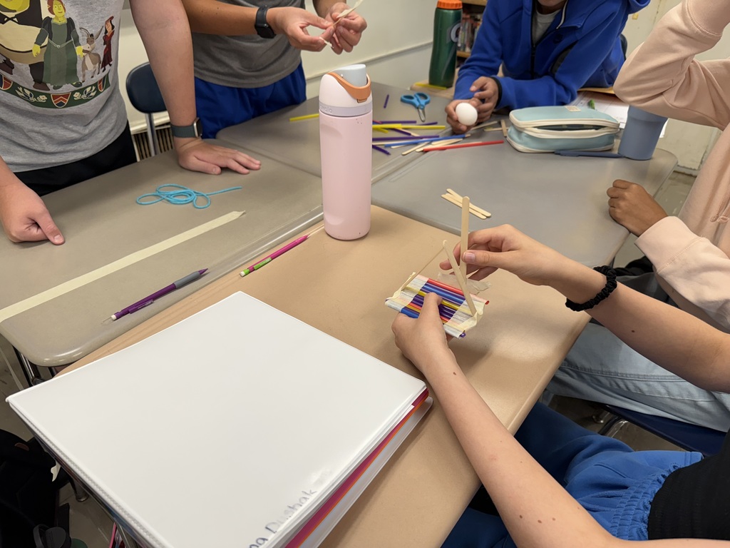 students working with straws and sticks