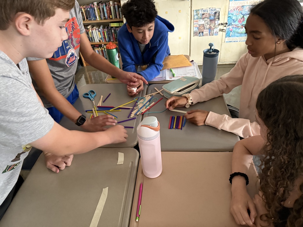 students working with straws and sticks