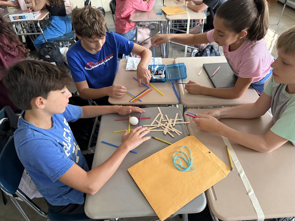 students working with straws and sticks