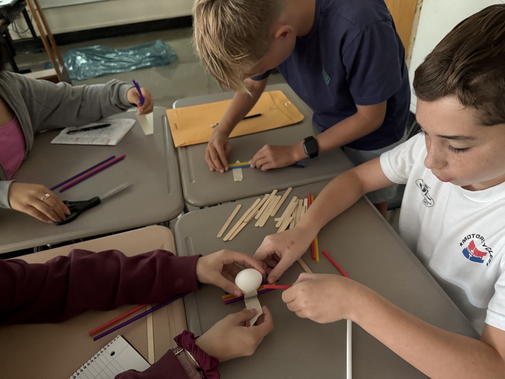 students working with straws and sticks