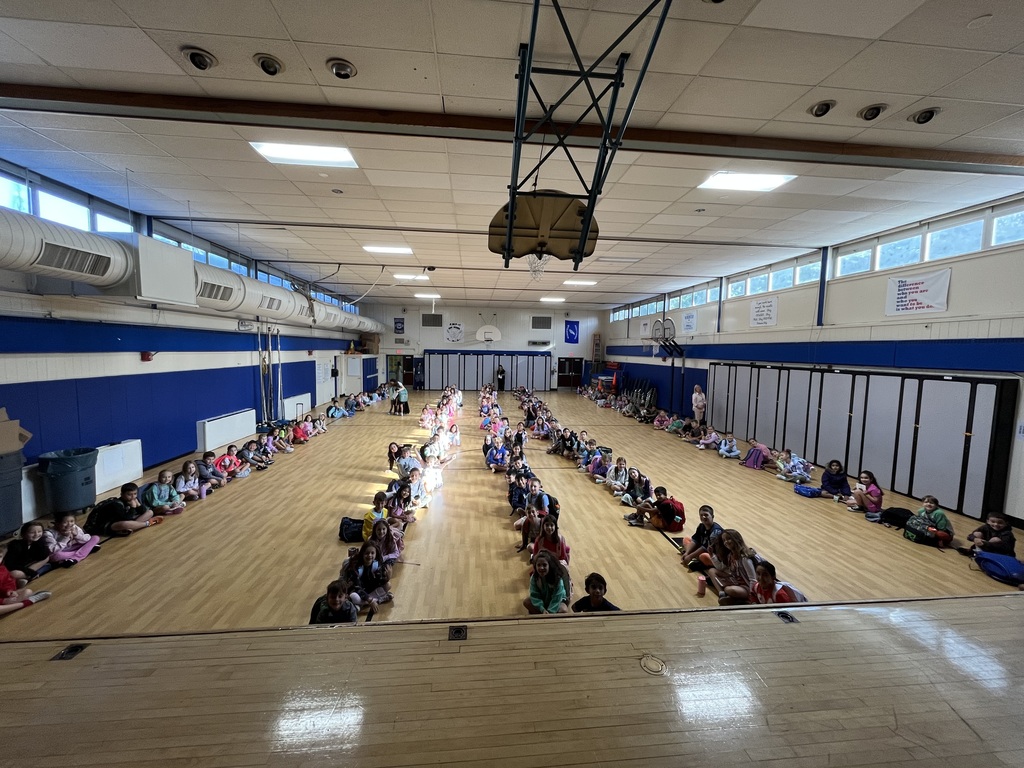 1st and 2nd graders sitting perfectly during our morning line up in the gym.
