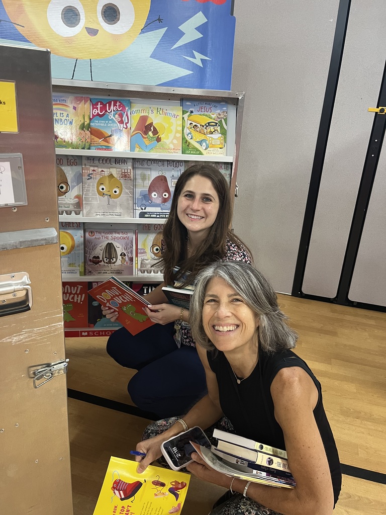 Two teachers are excited about the new books.