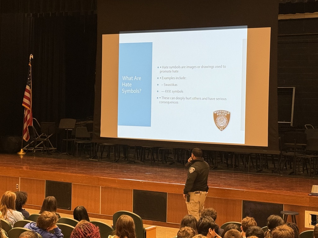 police officer presenting to crowd of students