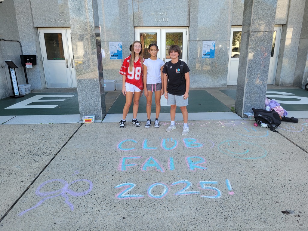 Students standing in front of chalk writing