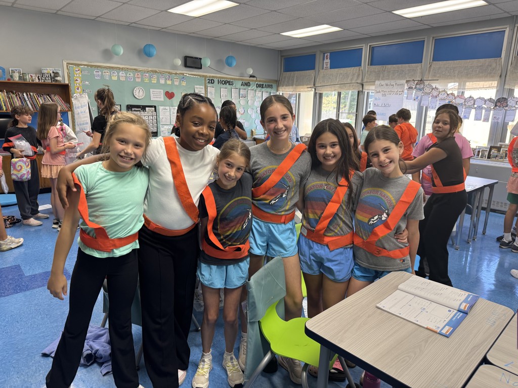 Safety patrol students are proudly wearing their orange belts.