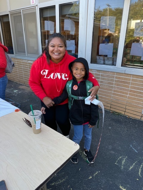 Parent volunteer and student pose for the photo.