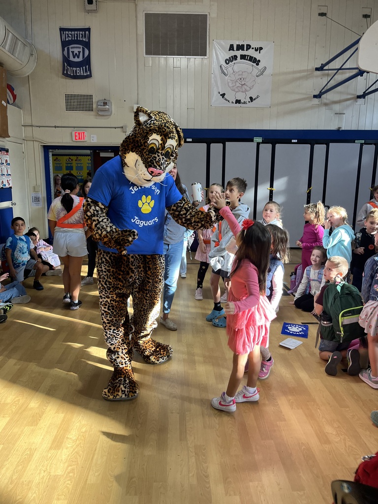 Jazzy gives high fives to our 1st graders.