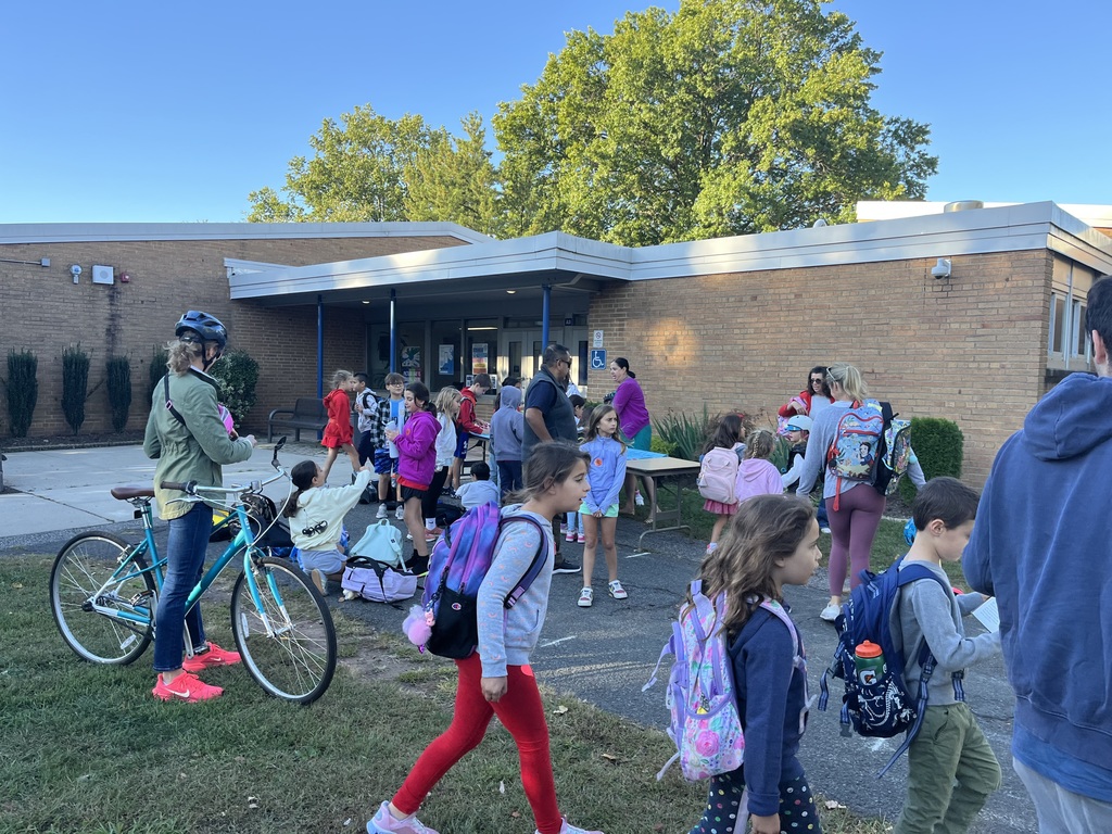 Students gathering for arrival and signing the banner.