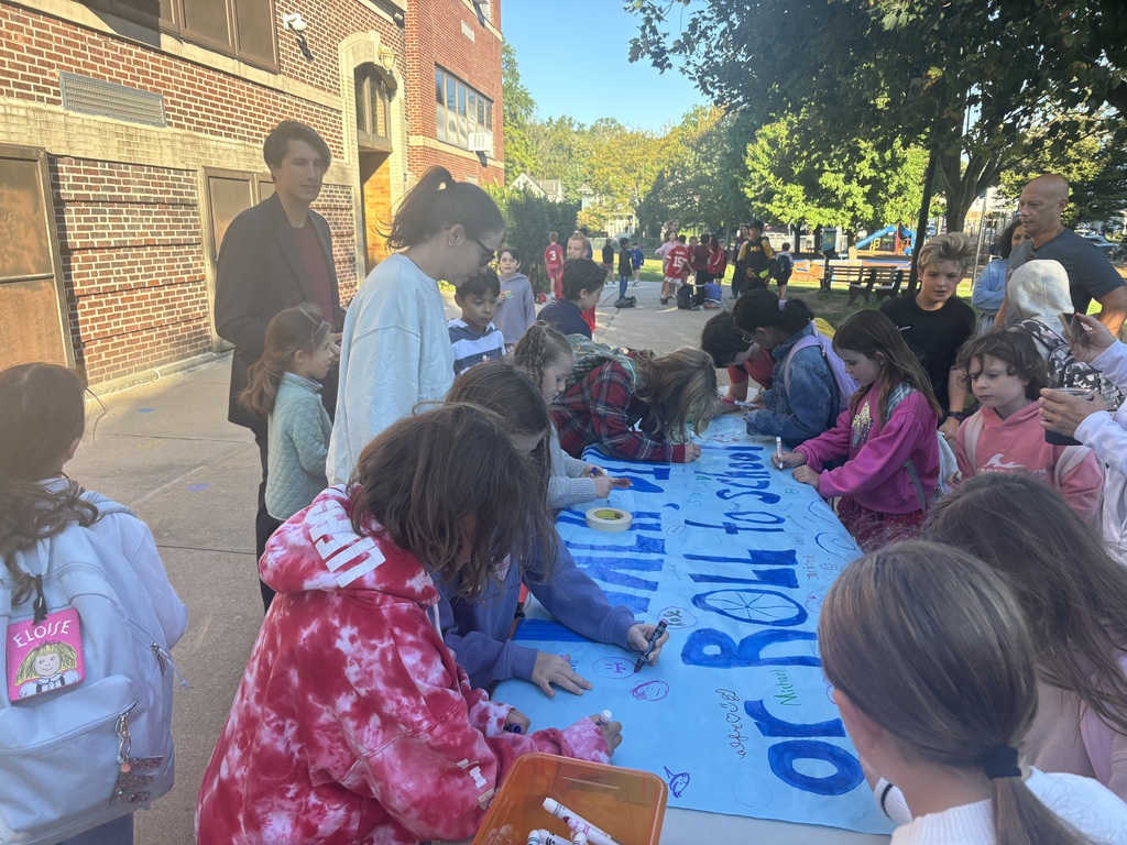 Students signing banner for Walk to School Day