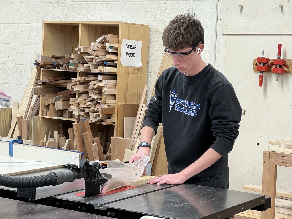 Student cuts aa piece of wood