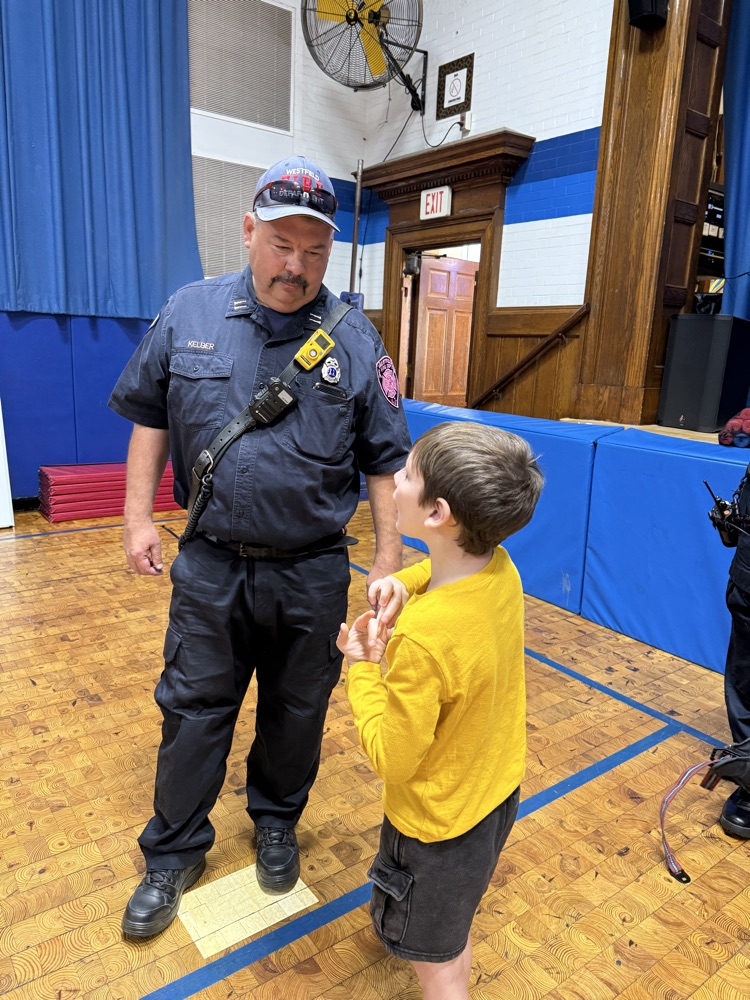 student talking to fire fighter