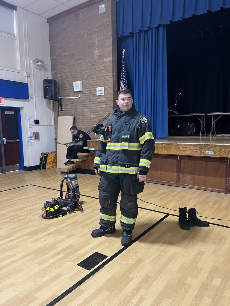 Fire fighter puts on his fire safe gear.