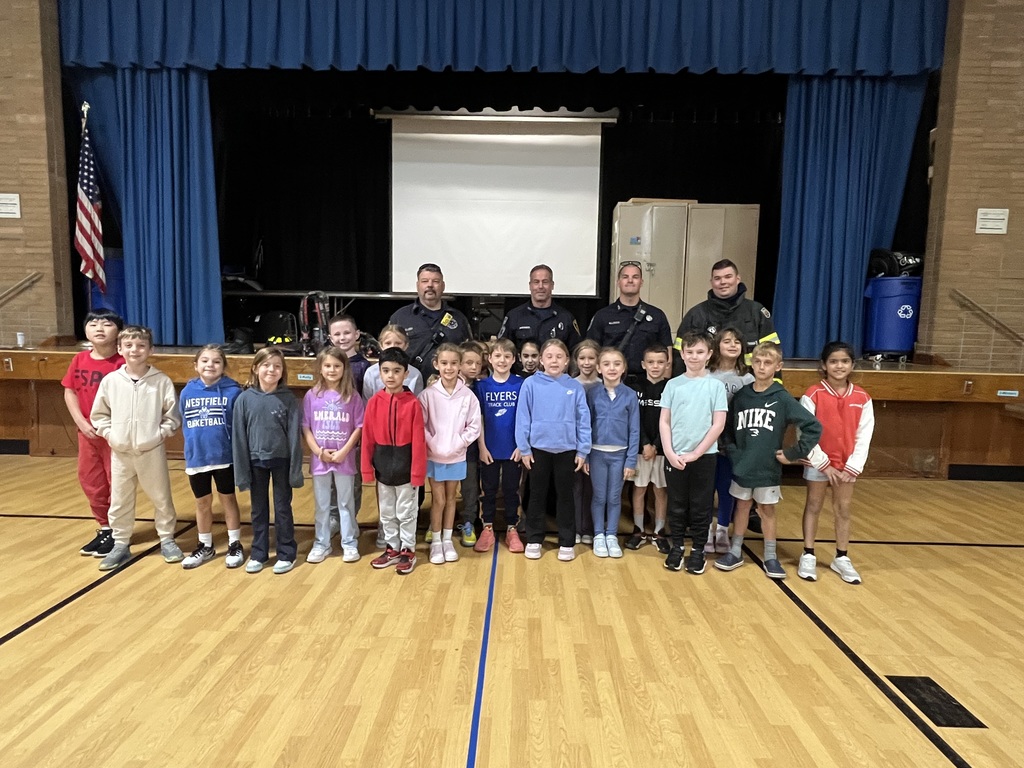Students are proud to be photographed with the members of the fire department.