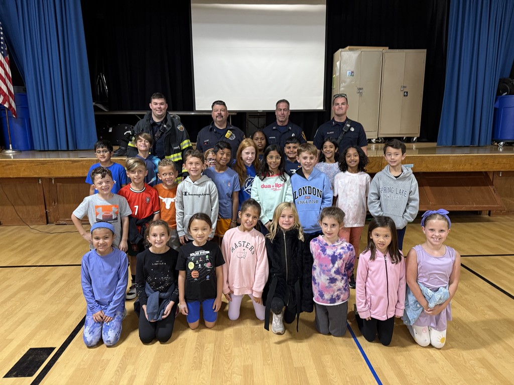 Students are proud to be photographed with the members of the fire department.