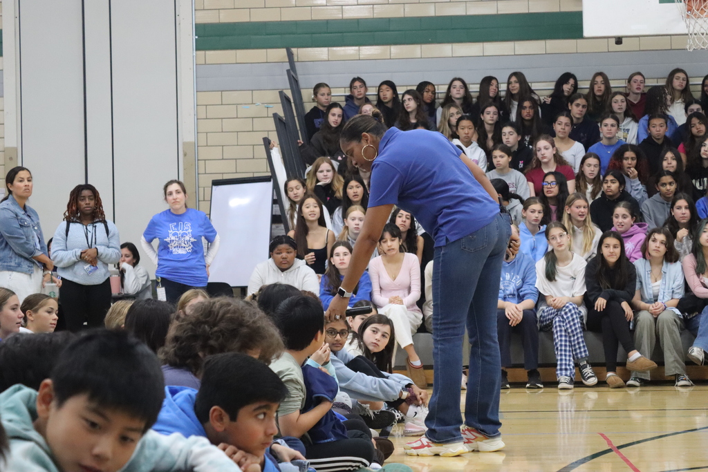 woman holding microphone to student
