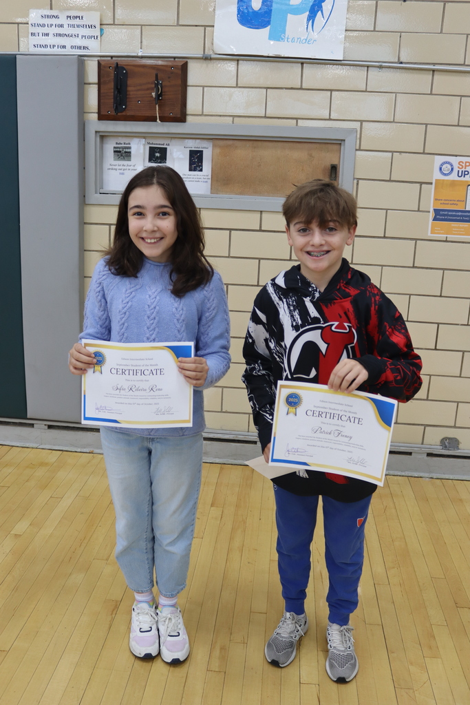6th grade students holding certificates
