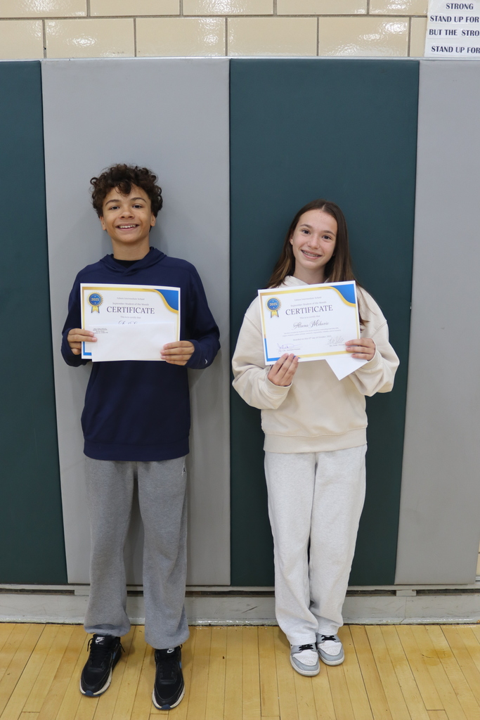 8th grade students holding certificates
