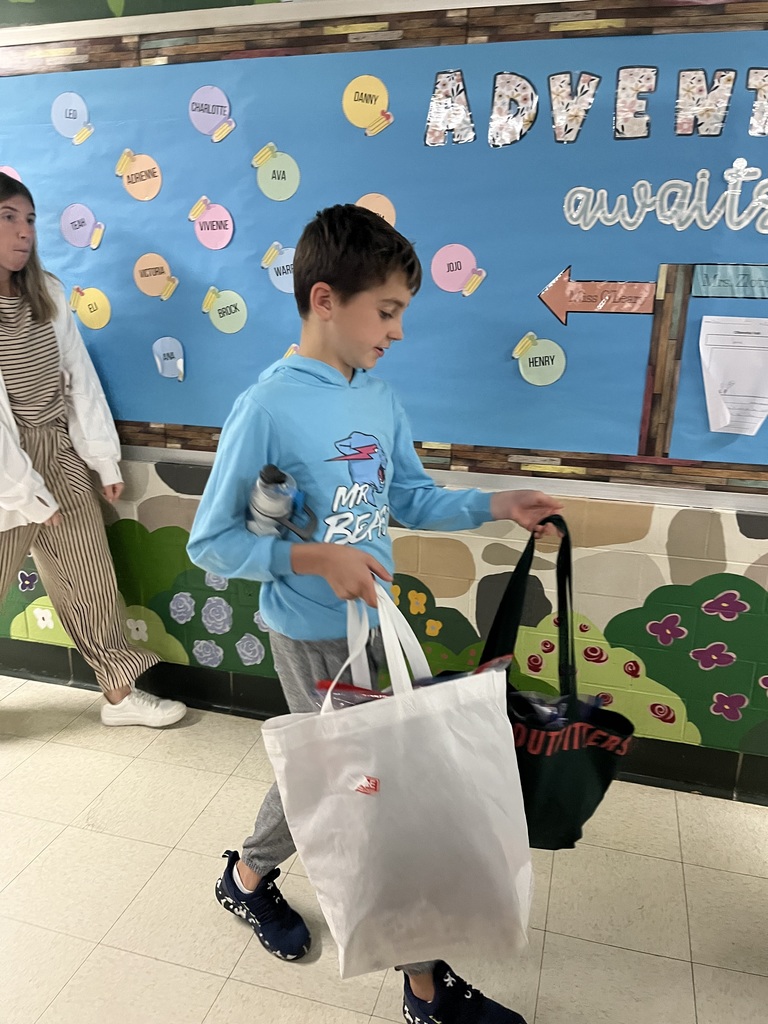 Student helps organize the donated costumes.