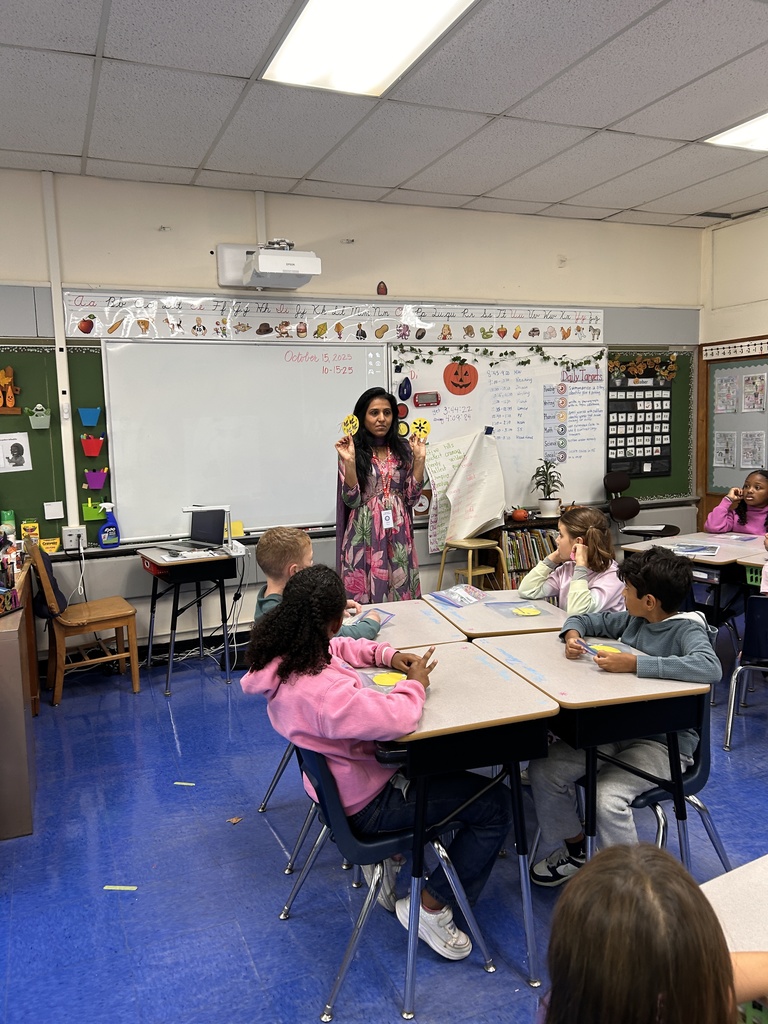 Parents showing students how to make the craft.