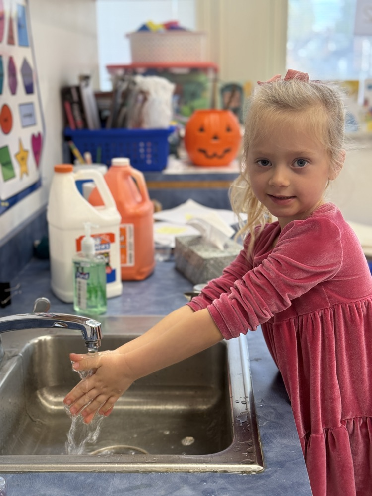 student washes hands prior to snack time