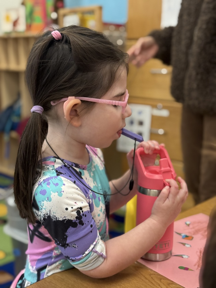 student demonstrates independence opening her water bottle