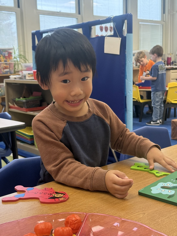 student engages with puzzles during choice time
