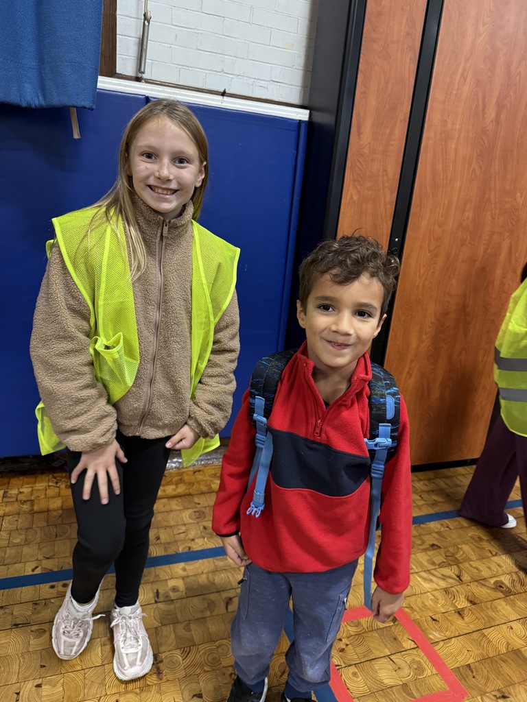 a safety patrol member standing with a student