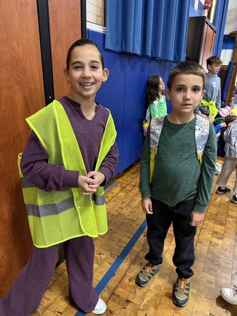 a safety patrol member standing with a student