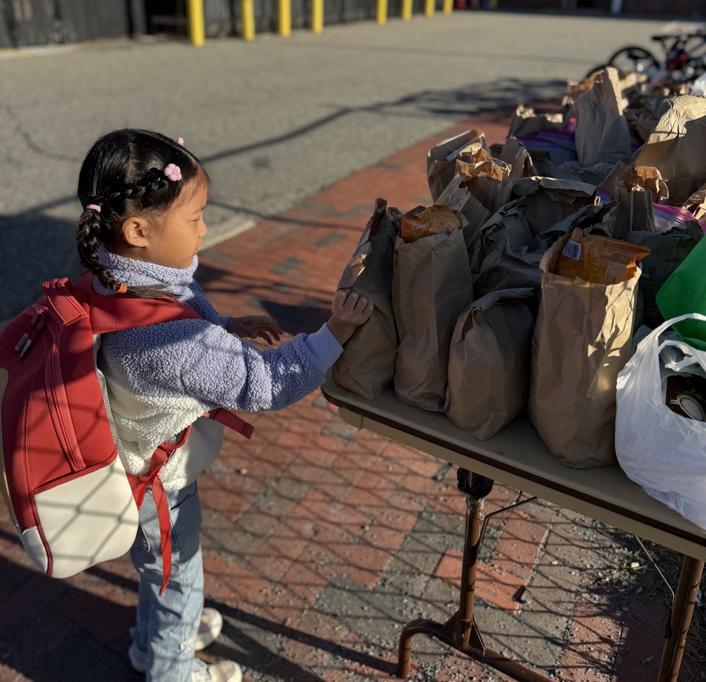 student placing donation on table