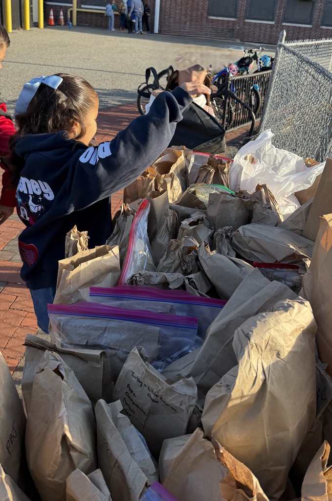 student placing donation on table