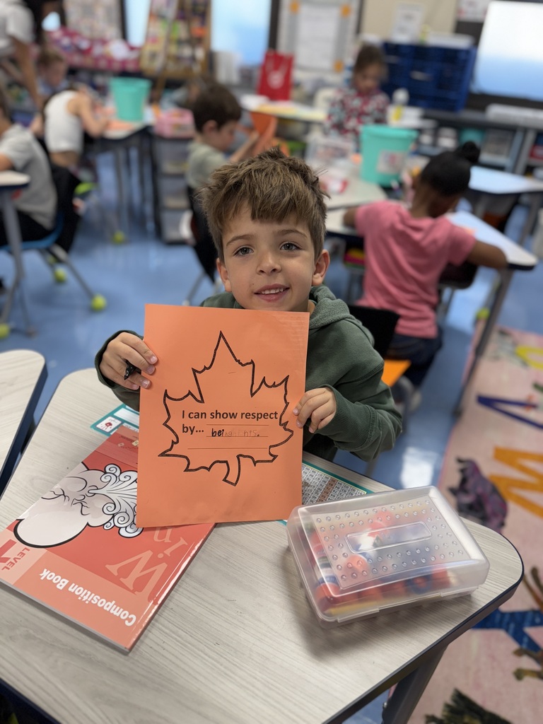 student holding up a leaf of respect
