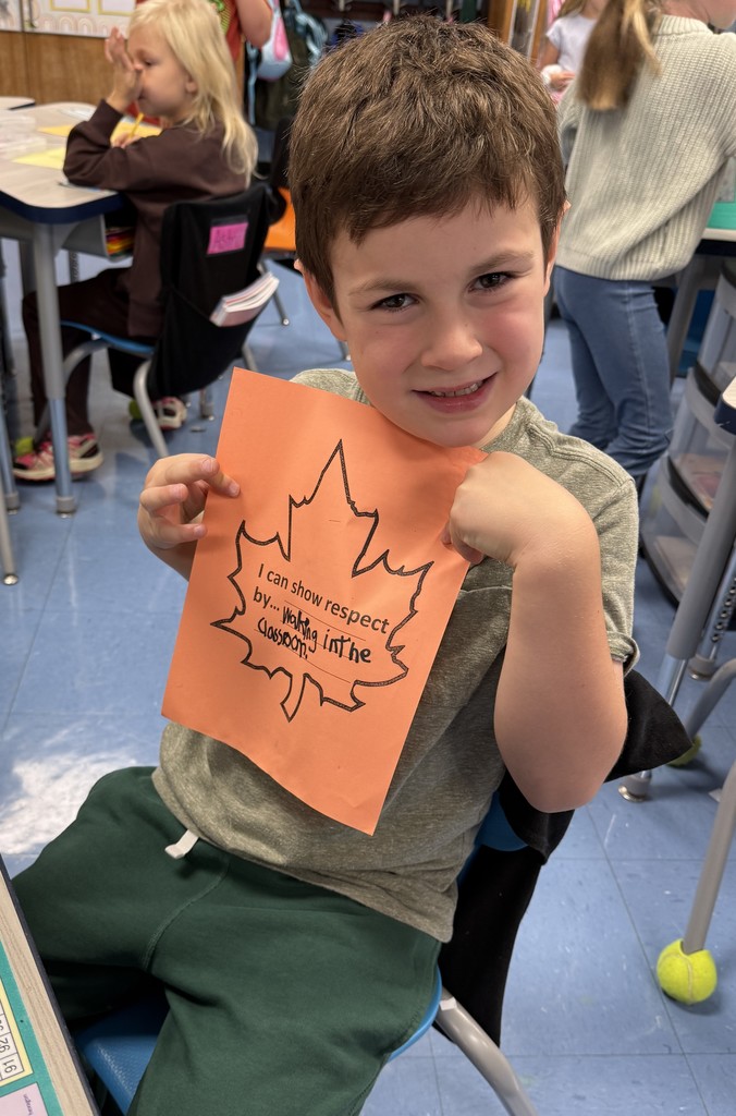 student holding up a leaf of respect