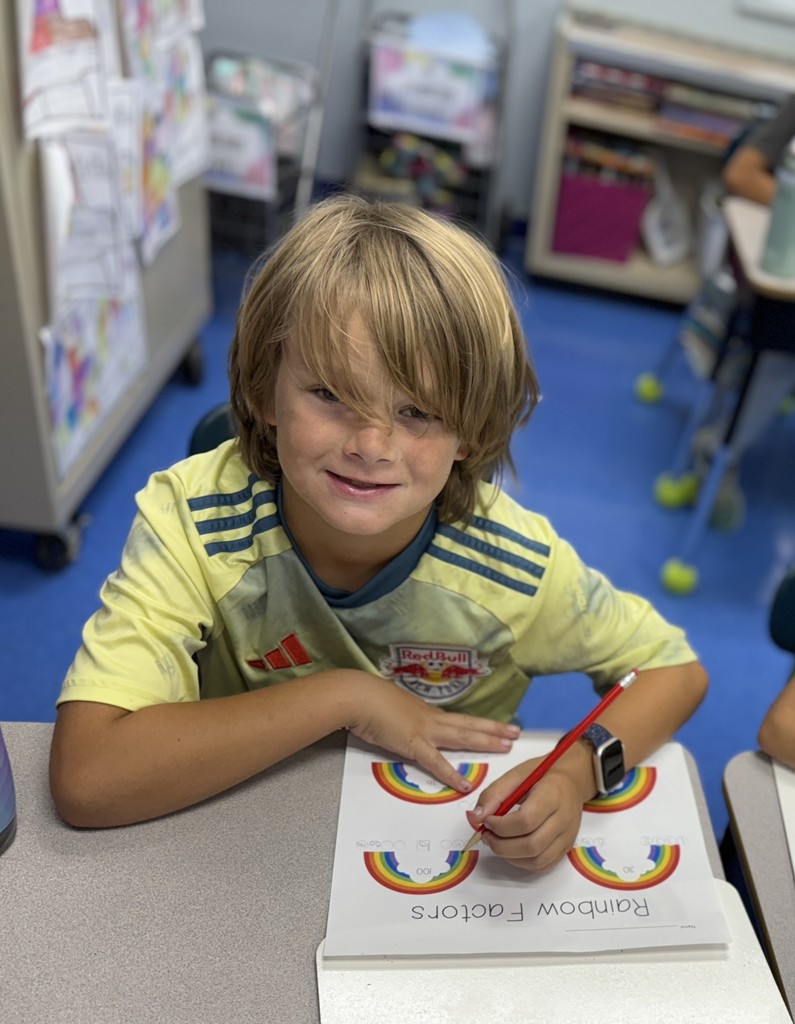 student working on factor rainbows