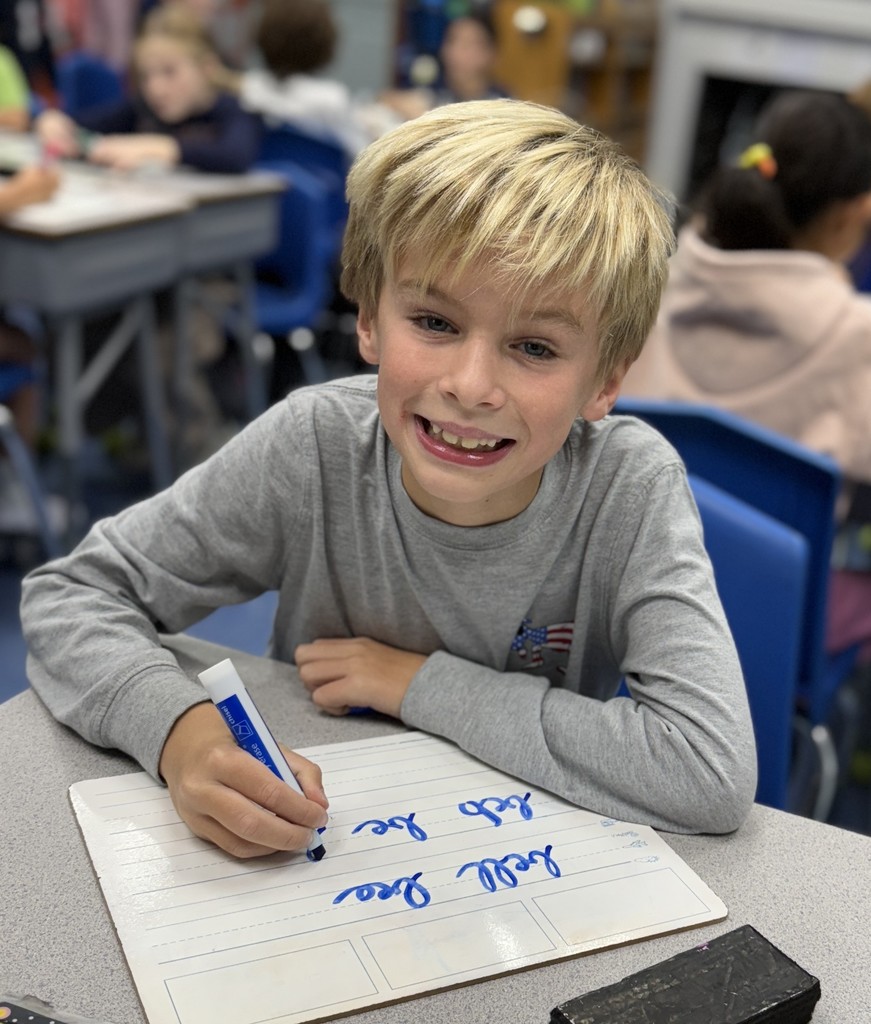 student practicing cursive writing