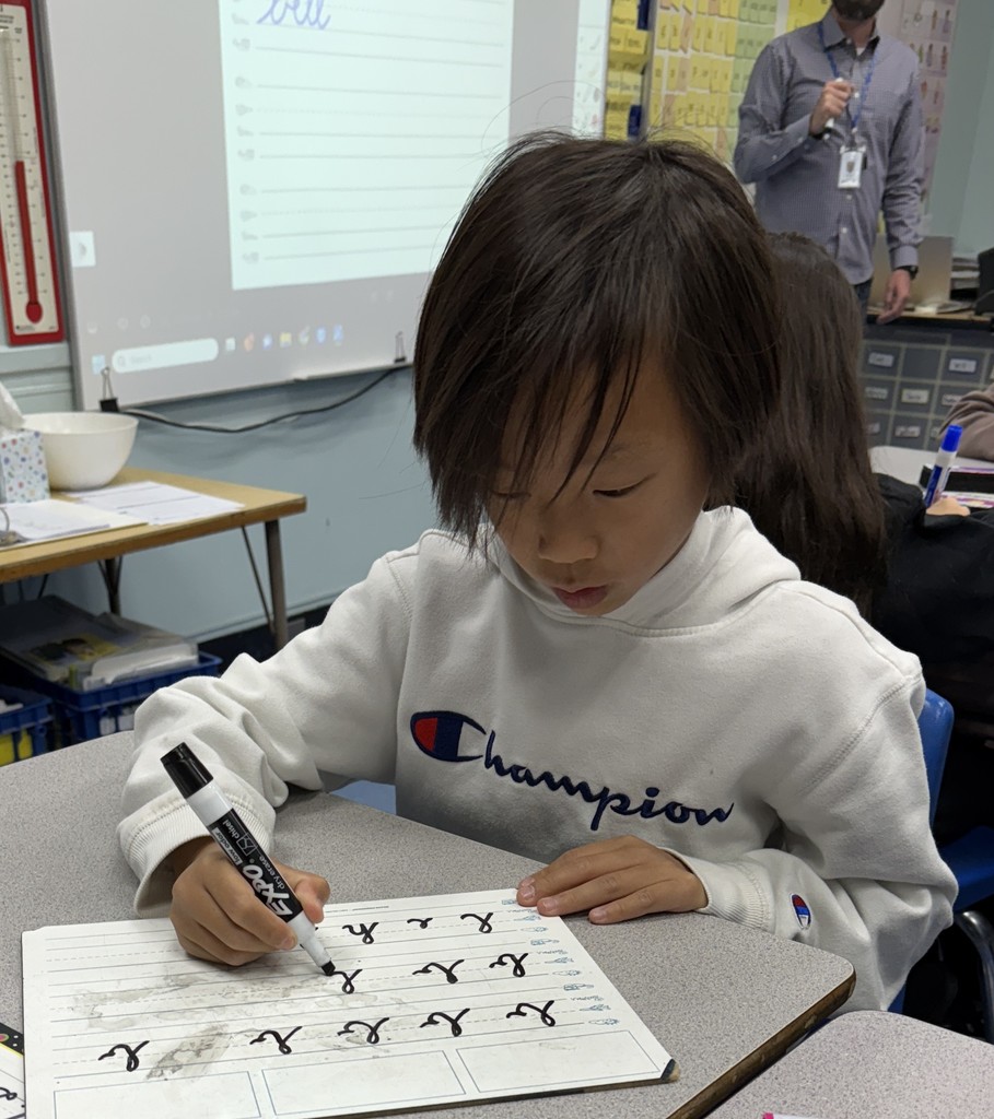 student practicing cursive writing
