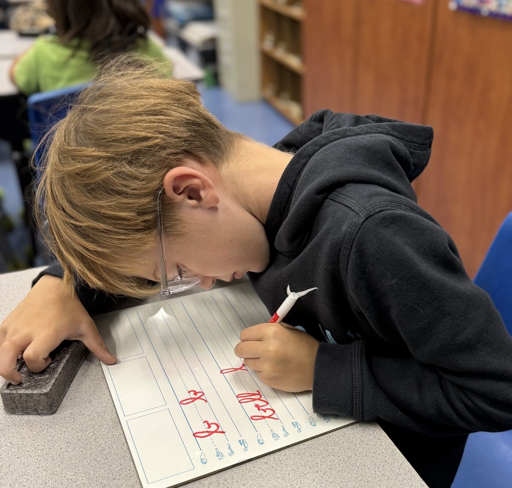 student practicing cursive writing