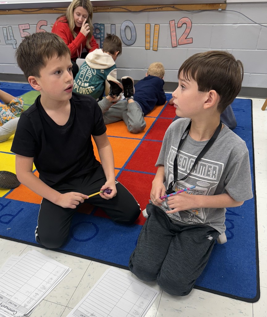 second grade students working together on a community helpers activity