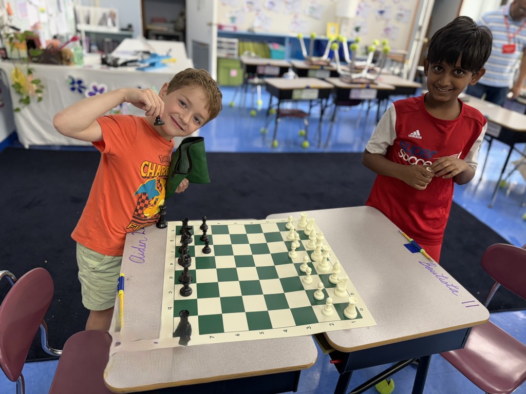 students standing near chess set
