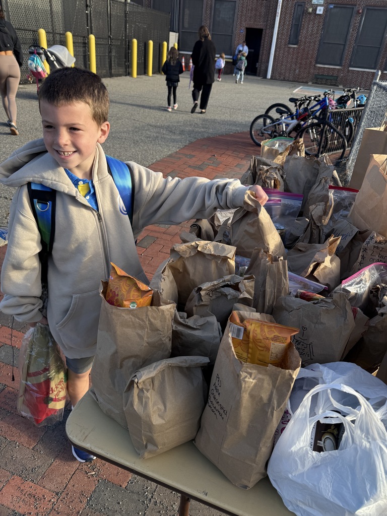 student placing extra lunch on donation table