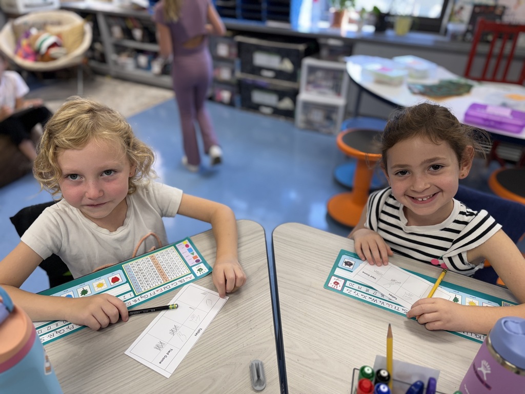 first graders working with a partner in math centers