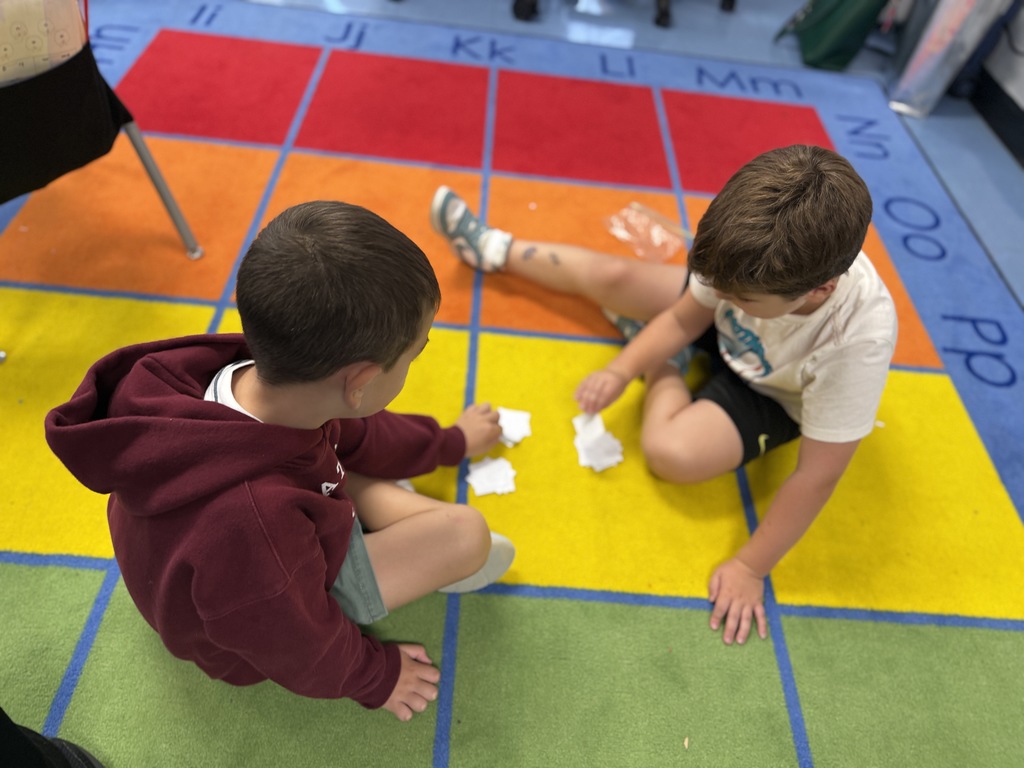 first graders working with a partner in math centers