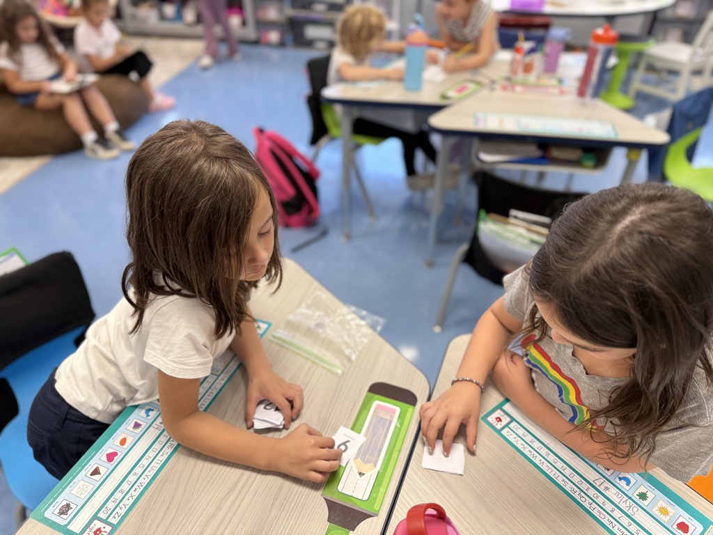 first graders working with a partner in math centers