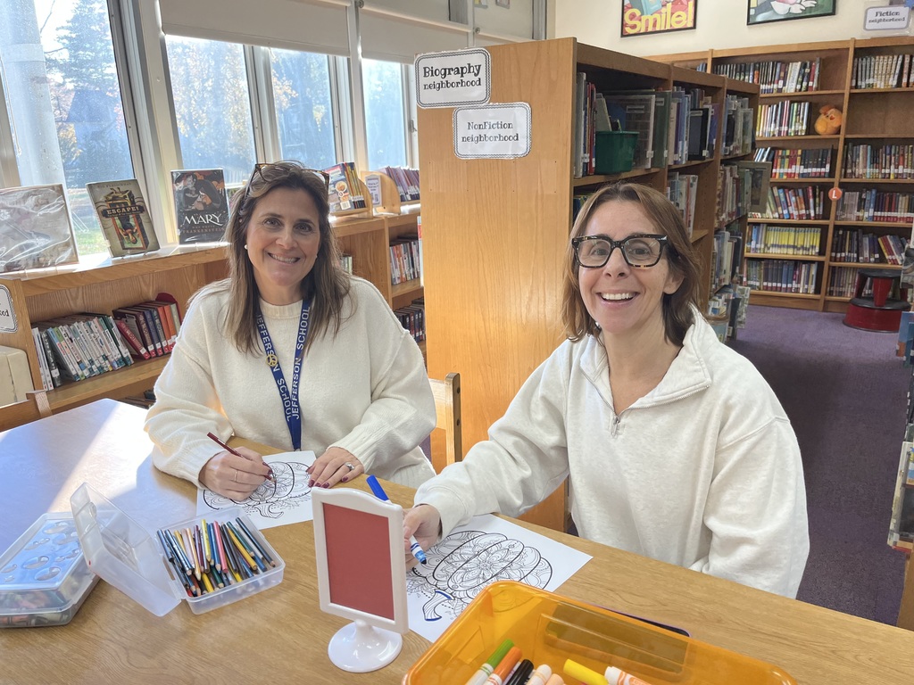 Teachers engaged in mindful coloring.