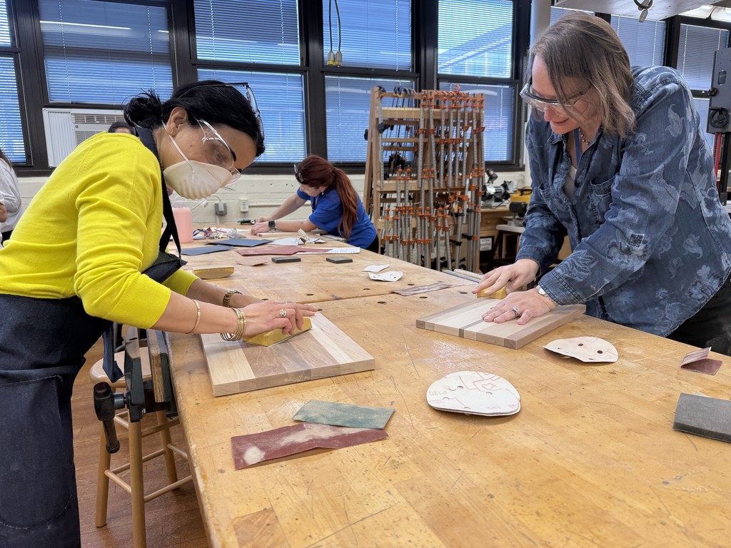 Teachers sanding cutting boards