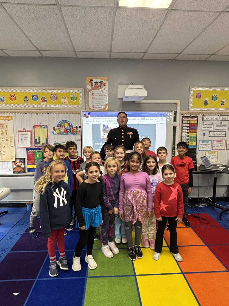 Students take a photo with the veteran.