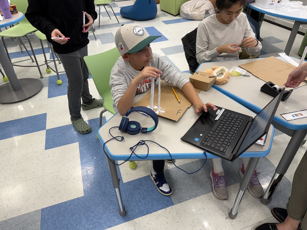 student with laptop and project